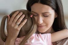 Loving caring adult woman foster parent mom holding little kid daughter giving comfort, protection and support concept, young tender single mother hugging adopted small child feeling love cuddling